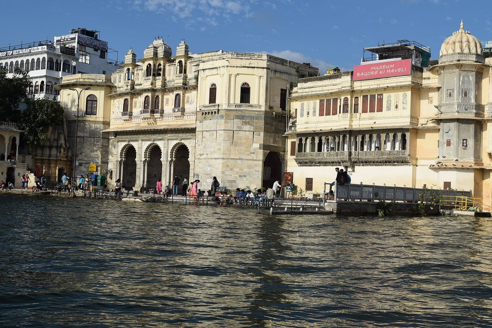 The cream façade of Bagore Ki Haveli rising from the water of Lake Pichola, Udaipur