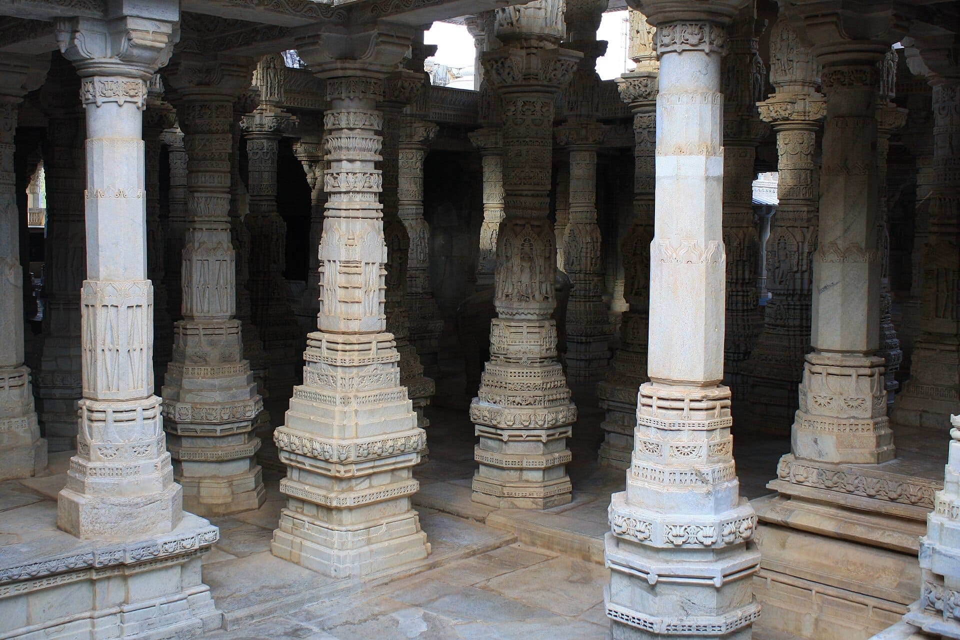 Rows of carved white marble columns inside Ranakpur Jain Temple