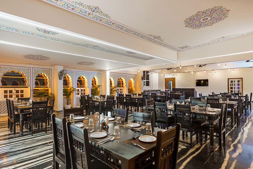 Restaurant interior with warmly lit arched alcoves and dark-wood furniture