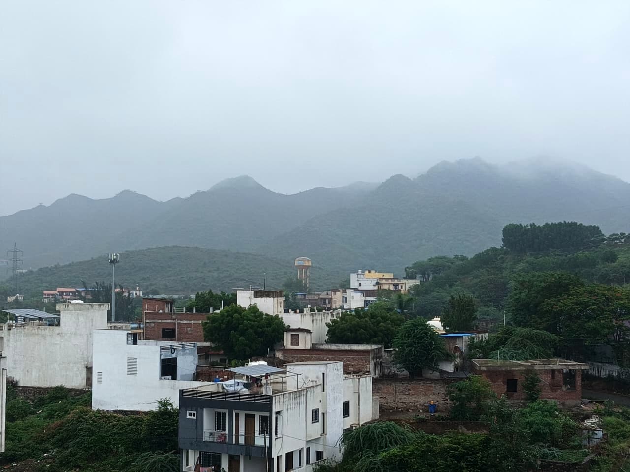 Low cloud over the green hills behind Sukher