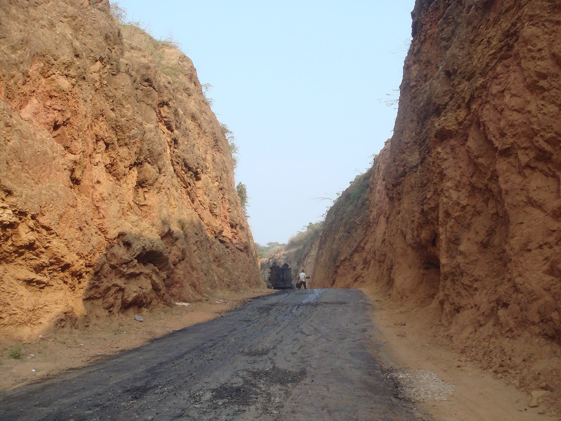 A narrow road at Haldighati, cut between walls of ochre-red rock