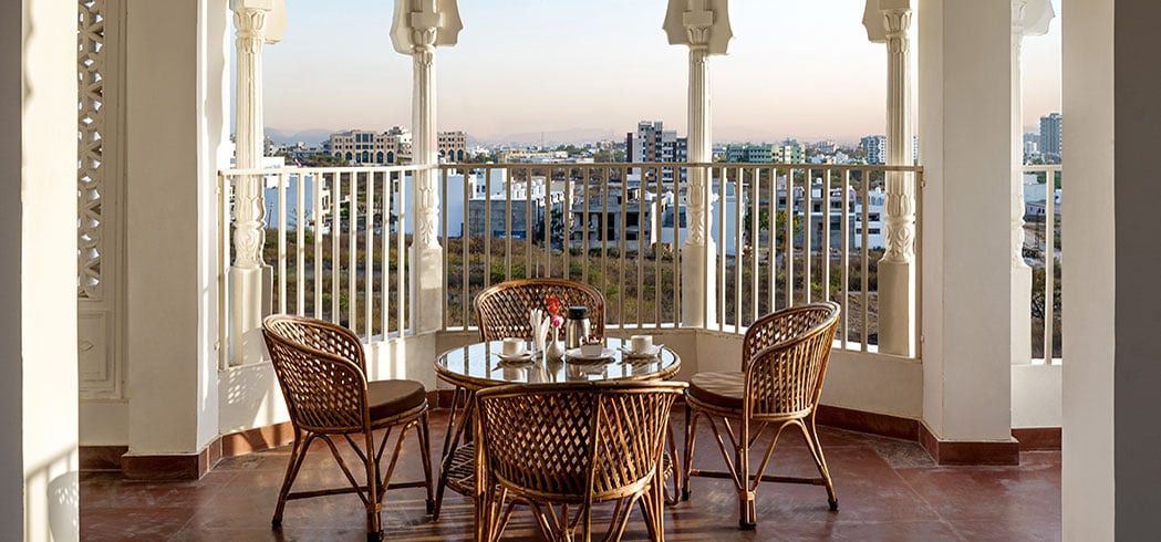 Roof Top Cafe seating framed by white cusped arches with the city beyond